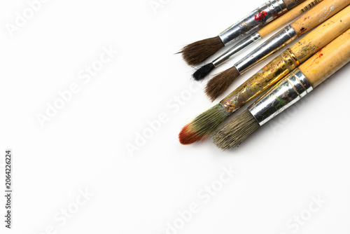Set of used paintbrushes on white background