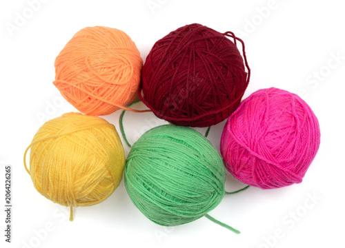Bright orange, red, pink, yellow, and green yarn balls isolated