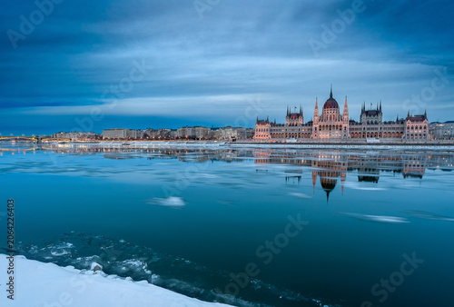 Illuminated Hungarian Parliament Building at Blue Hour over Frozen Danube River, Budapest