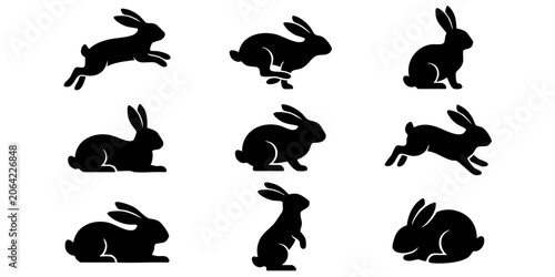 Several rabbits are running and sitting in various positions outdoors.