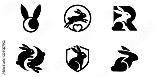 Obraz na płótnie Black silhouettes of rabbits in various poses and symbols on white background