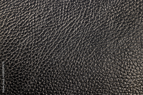 Konstfotografi details of a natural black leather bag after prolonged use, dark color