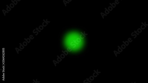 Glowing green orb light effect on black background