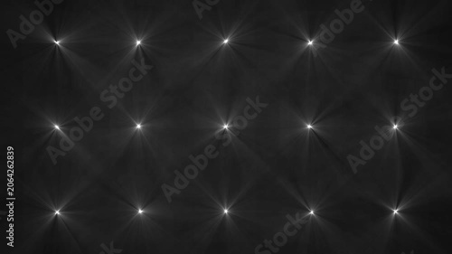 Cinematic stage lighting array with glowing white beams and haze