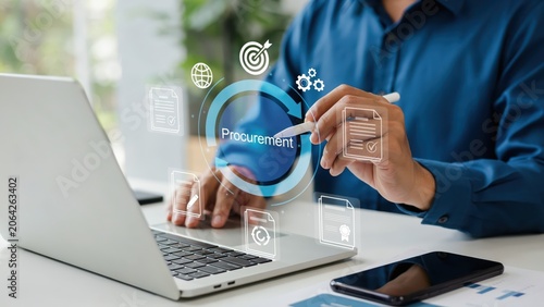 Business person using a laptop with digital procurement icons on a modern desk