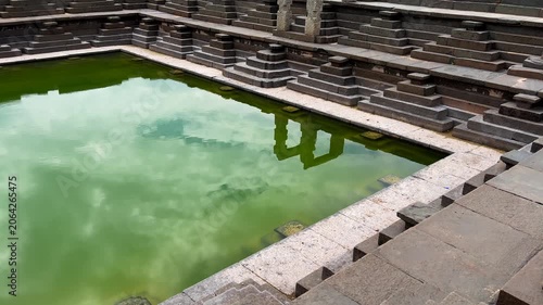 Ancient stepped tank at the UNESCO World Heritage Site of Hampi, Karnataka, India, showcasing the remarkable water management and architectural ingenuity of the Vijayanagara Empire