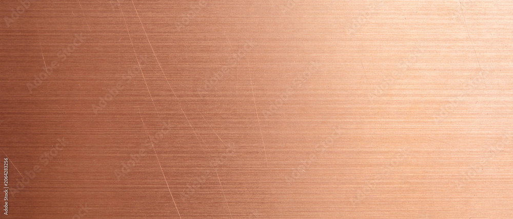Fototapeta premium Brushed bronze metal surface with fine horizontal lines and subtle scratches