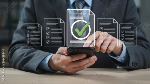 Businessman using smartphone to manage digital documents with green check mark icon