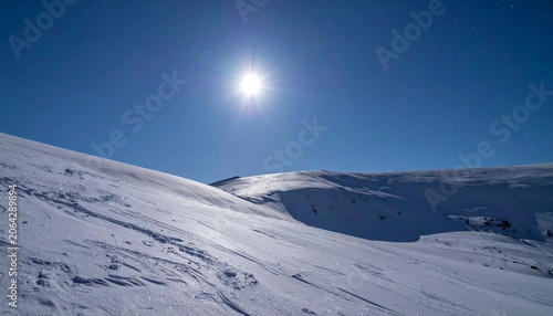 Snowy mountain landscape under sunlight