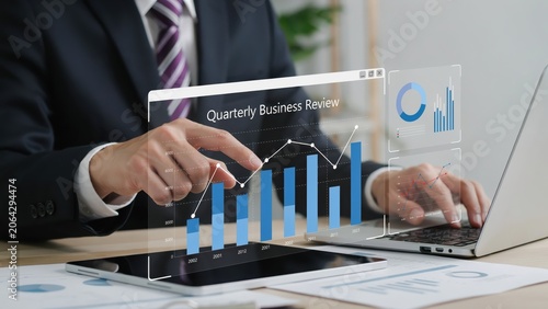Businessman analyzing financial data and quarterly business review on a tablet