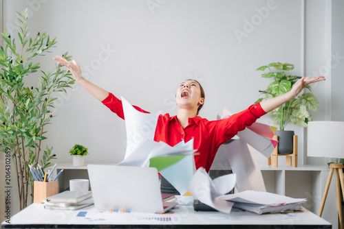 Slika na platnu Overwhelmed with Joy: A woman in an office setting celebrates exuberantly, throwing papers in the air with arms outstretched in a moment of pure elation and accomplishment