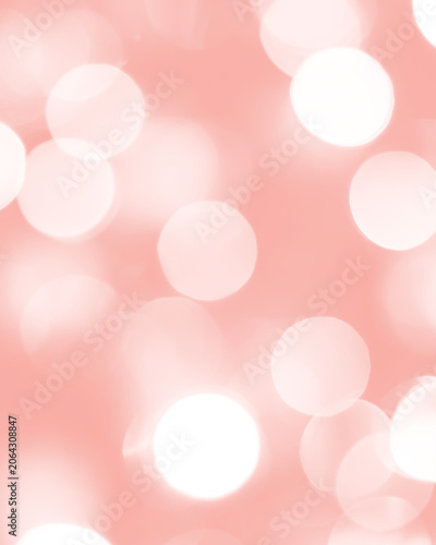 Soft pink bokeh background with blurred glowing light circles, festive decorative texture