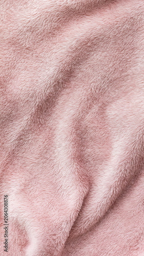 Soft pink faux fur fabric, close up texture of plush textile material