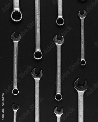 Collection of metal wrenches on black background