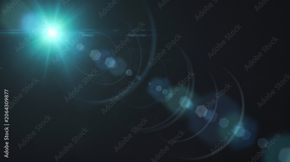 Fototapeta premium Blue lens flare with circular light rings on dark.