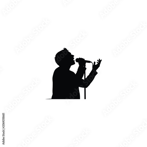 Silhouette of a male singer performing into a microphone on a stand with an expressive hand gesture. Concept of live music performance, concert, entertainment, and artistic expression.