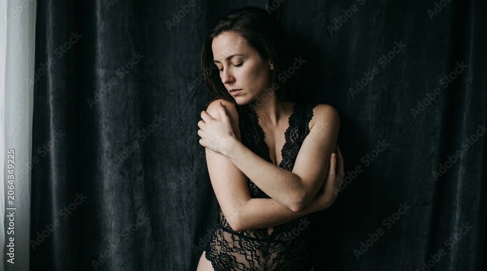 Fototapeta premium Macro photo of a woman in black lace showing woman's features showing delicate skin pores natural beauty details and high-resolution skin texture with professional studio lighting
