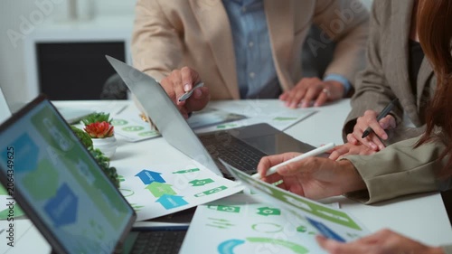 Business team collaborating on an environmental project, discussing corporate sustainability and social responsibility with esg reports and data analysis for a green and eco friendly business plan