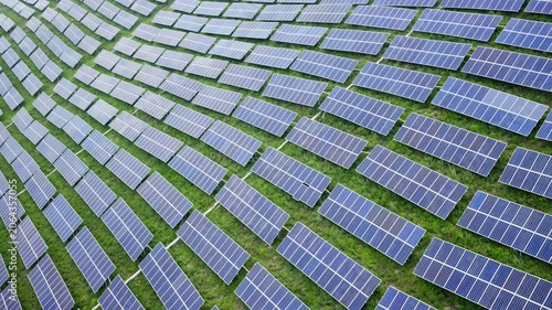 Aerial View of Solar Panels on Green Hillside Agrivoltaics Concept