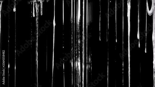 The liquid forms textured lines, some of which appear stretchy and sticky at the top (resembling a spiderweb or slime), creating a sharp contrast against the solid black background.