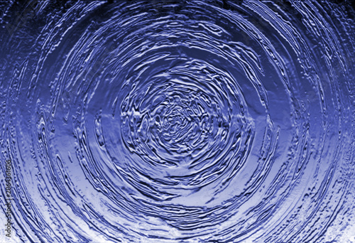 Concentric water ripples, blue-toned photograph with circular pattern