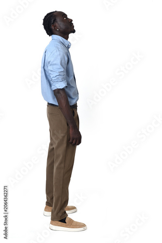 side view of a man standing  looking up on white background