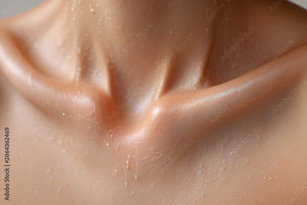 Fototapeta premium Close up of a person's neck and clavicle with glitter and water drops