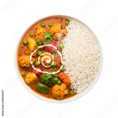 Bowl of vegetable korma with steamed white rice garnish and cream swirl top view.