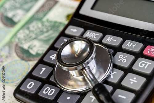 Stethoscope, calculator - health care costs concept