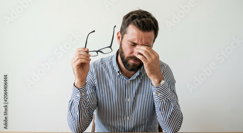 exhausted or stressed young adult man