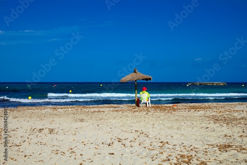 Lifeguard on the beach of Cala Moreia in the resort of S´illot on the island of Mallorca in the Balearic Islands in Spain.