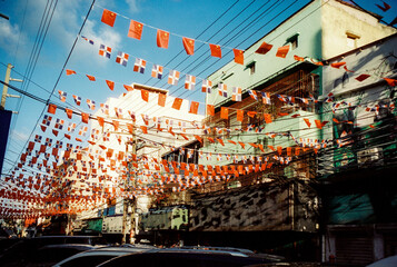 Chinese and Dominican flags in Chinatown street
