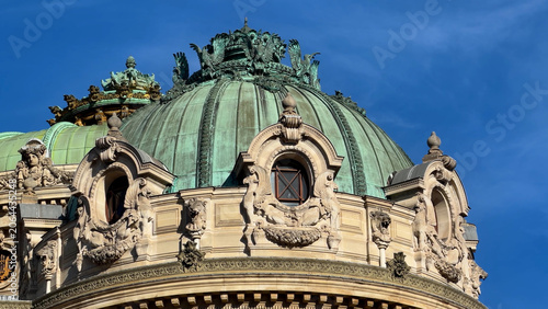 Photos Ornate green copper dome with sculpted stone balustrade against blue sky