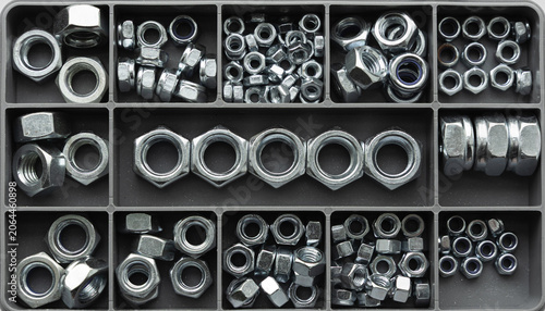 Obraz na plátně Assorted metal hex nuts organized in compartment storage box