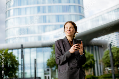 Woman holding phone outside...