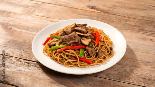 Noodles with meat and vegetables on plate