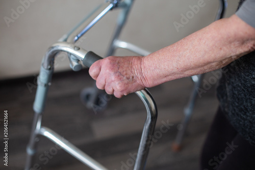 Foto Senior woman using a walker for mobility support