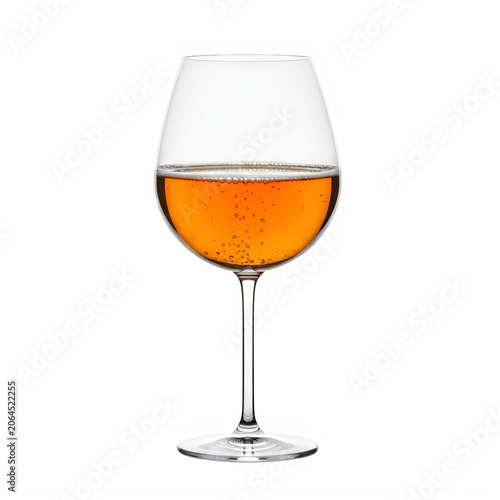Glass of orange wine on a reflective surface