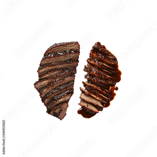 Two halves of juicy sliced beef brisket glazed