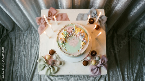 A beautifully decorated cake with pastel frosting and decorative