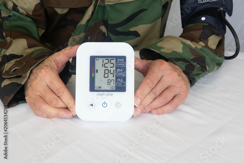 Принти на полотні Veteran Taking Blood Pressure Reading Shows High Systolic and Diastolic Numbers