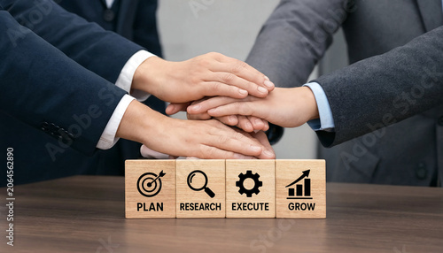 Teamwork concept with wooden blocks displaying business strategy phases
