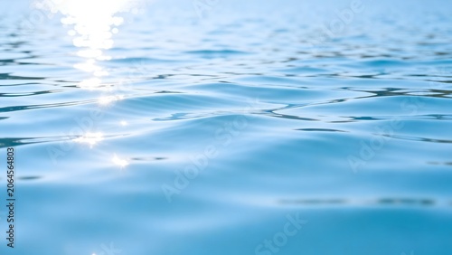 Sunlit ripples on blue water surface