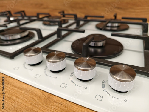 Kitchen white built in gas range showing detailed control knobs in a retail warehouse ideal for modern cooking setups