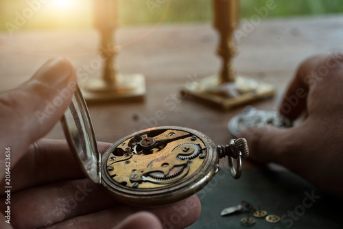 Watchmaker repairing vintage mechanical watches in an antique workshop
