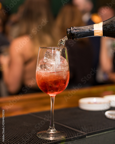 Refreshing Red Cocktail Being Poured at a Bar