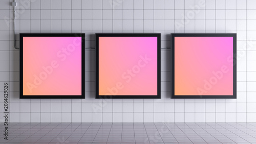 Three square lightboxes in matte black frames arranged in a row on a white square-tiled wall.
