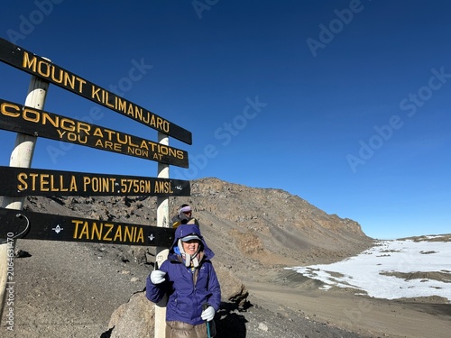 Obraz na płótnie Senior Asian woman hiker at Stella Point on Mount Kilimanjaro during summit asce