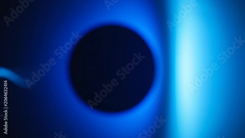 Dark circle with glowing blue light abstract background