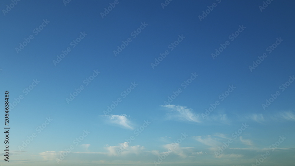 Obraz premium A Serene, Beautiful Blue Sky Graced with Wispy, Light Clouds Floating Gracefully Above
